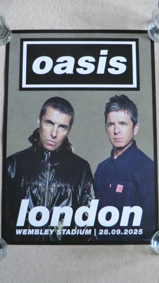 Promotional poster for Oasis concert at Wembley Stadium in London, featuring two band members.